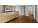 Cozy bedroom featuring wood-look floors, neutral paint, large window, and nice sunlight at 1619 Abby Ave, Henderson, NV 89014