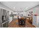 Spacious kitchen featuring stainless steel appliances, a dining table, white cabinets, and wood flooring at 1619 Abby Ave, Henderson, NV 89014