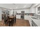 Bright kitchen with white cabinets, stainless steel appliances, a dining table, and wood flooring at 1619 Abby Ave, Henderson, NV 89014
