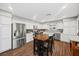Modern kitchen boasts stainless steel appliances, a dining table, and white cabinets with ample counter space at 1619 Abby Ave, Henderson, NV 89014