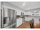 Bright kitchen features stainless steel appliances, white cabinets, sleek countertops, and wood-look flooring at 1619 Abby Ave, Henderson, NV 89014