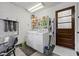 Functional laundry area with washer, dryer, storage shelves, and convenient access to the outside at 1619 Abby Ave, Henderson, NV 89014