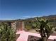 Landscaped backyard featuring desert plants and a pink sidewalk at 18 Brookridge Dr, Henderson, NV 89052