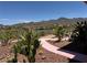 Landscaped backyard featuring desert plants, gravel pathways and views of mountains and the golf course at 18 Brookridge Dr, Henderson, NV 89052