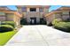 Home exterior with a stone facade, well-manicured bushes and lawn at 18 Brookridge Dr, Henderson, NV 89052