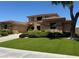 Exterior shot features well manicured lawn, mature trees and manicured bushes at 18 Brookridge Dr, Henderson, NV 89052