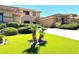 Exterior shot features well manicured lawn, mature trees and manicured bushes at 18 Brookridge Dr, Henderson, NV 89052