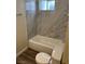 Bathroom featuring gray tiling, a white porcelain tub, and updated fixtures at 1809 Lamplighter Ln, Las Vegas, NV 89104