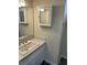 Bathroom featuring a vanity with a mirror, medicine cabinet, and a neutral color scheme at 1809 Lamplighter Ln, Las Vegas, NV 89104