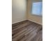 Bright bedroom showcases new wood-look floors, base molding and a large sunny window at 1809 Lamplighter Ln, Las Vegas, NV 89104