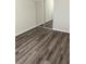 Bedroom features updated wood-look flooring, a mirrored closet, and base molding at 1809 Lamplighter Ln, Las Vegas, NV 89104