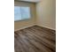 Inviting bedroom with wood-look floors and a sunny window, perfect for relaxing at 1809 Lamplighter Ln, Las Vegas, NV 89104
