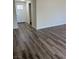 Fresh entryway view highlighting the wood-look flooring, front door, and leading into other rooms at 1809 Lamplighter Ln, Las Vegas, NV 89104