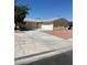 Cozy single-story home featuring an attached two-car garage, neutral paint and low maintenance landscaping at 1809 Lamplighter Ln, Las Vegas, NV 89104