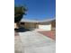 Cozy single-story home featuring an attached two-car garage, neutral paint and low maintenance landscaping at 1809 Lamplighter Ln, Las Vegas, NV 89104
