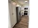 Bright kitchen showcasing stainless steel appliances, white cabinets, pantry and stylish laminate flooring at 1809 Lamplighter Ln, Las Vegas, NV 89104