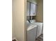 A functional laundry room featuring a side by side washer and dryer and storage cabinet at 1809 Lamplighter Ln, Las Vegas, NV 89104