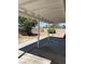 Covered patio offers shade and overlooks a backyard featuring mature trees at 1809 Lamplighter Ln, Las Vegas, NV 89104