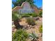 La Posada community entrance sign featuring lush landscaping with desert plants and decorative stones on a sunny day at 1908 Rio Canyon Ct # 105, Las Vegas, NV 89128