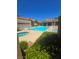 Sparkling community pool with comfortable lounge chairs, umbrellas, and spa offering a refreshing outdoor experience at 1908 Rio Canyon Ct # 105, Las Vegas, NV 89128