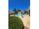 Inviting community pool featuring lounge chairs, umbrellas, and clear blue water for relaxation and enjoyment at 1908 Rio Canyon Ct # 105, Las Vegas, NV 89128