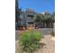 Exterior of building with well maintained landscaping and decorative orange flowers in view at 1908 Tierra Vista Dr # 210, Las Vegas, NV 89128