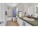 Bathroom featuring white cabinets, wood-look floors, and a shower/tub combo at 2084 Airy Petals Walk, Henderson, NV 89044