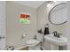 Stylish half-bathroom with a modern vanity, round mirror, and clean design, offering a convenient and chic space at 2084 Airy Petals Walk, Henderson, NV 89044