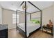 Bedroom showcasing a four-poster bed, contemporary furnishings, and natural lighting at 2084 Airy Petals Walk, Henderson, NV 89044