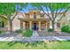 Charming two-story home featuring a cozy front porch, well-maintained landscaping, and a welcoming blue front door at 2084 Airy Petals Walk, Henderson, NV 89044