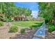 Lush green space with walking path, bordered by houses and mature trees, offers a scenic view at 2084 Airy Petals Walk, Henderson, NV 89044
