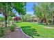 Expansive green space with lush grass, walking paths, and mature trees in a serene setting at 2084 Airy Petals Walk, Henderson, NV 89044