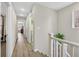 Bright hallway with wood-look floors, leading to bedrooms, laundry room and bathroom at 2084 Airy Petals Walk, Henderson, NV 89044