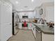 Modern kitchen with stainless steel appliances, white cabinetry, and sleek countertops, providing a functional and stylish cooking space at 2084 Airy Petals Walk, Henderson, NV 89044