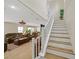 Bright and airy living space with a staircase, sleek floors, and open access to dining area, great for entertaining and Gathering at 2084 Airy Petals Walk, Henderson, NV 89044