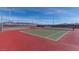 Well-maintained outdoor tennis courts featuring green playing surfaces, nets, and perimeter fencing at 2084 Airy Petals Walk, Henderson, NV 89044