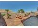 Backyard features a seating area with lush landscaping, creating a perfect oasis for relaxation and entertainment at 2217 Merrimack Valley Ave, Henderson, NV 89044
