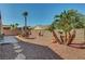 Expansive backyard featuring desert landscaping, a covered patio, and ample space for outdoor living and entertaining at 2217 Merrimack Valley Ave, Henderson, NV 89044