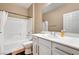 Bright bathroom with white cabinets, tile flooring, and a shower-tub combo with curtain at 2217 Merrimack Valley Ave, Henderson, NV 89044