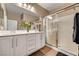 Bright bathroom features a double sink vanity and a glass-enclosed shower, creating a functional space at 2217 Merrimack Valley Ave, Henderson, NV 89044