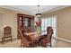 Elegant dining room with a stylish hutch, a wooden table set, and plantation shutters at 2217 Merrimack Valley Ave, Henderson, NV 89044