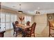 Well-lit dining room featuring plantation shutters and a decorative chandelier and ceiling fan at 2217 Merrimack Valley Ave, Henderson, NV 89044