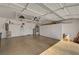 A clean, well-organized garage with ample storage cabinets, overhead racks, and epoxy flooring for functionality at 2217 Merrimack Valley Ave, Henderson, NV 89044