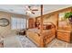 Cozy bedroom boasts four-poster bed, shuttered windows, and carpet flooring at 2217 Merrimack Valley Ave, Henderson, NV 89044