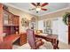 Tastefully decorated home office area with hardwood desk, cabinets, and a ceiling fan at 2217 Merrimack Valley Ave, Henderson, NV 89044