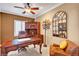 Home office features a ceiling fan, a wooden desk, hutch and chair, plus an arched mirror at 2217 Merrimack Valley Ave, Henderson, NV 89044