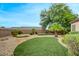 Expansive artificial turf backyard with desert landscaping at 2766 Mintlaw Ave, Henderson, NV 89044
