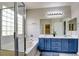 Bright bathroom features double sinks, a soaking tub with glass enclosed shower, and stylish tile flooring at 2766 Mintlaw Ave, Henderson, NV 89044