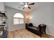 Bright bedroom with ceiling fan and seating beneath a large window at 2766 Mintlaw Ave, Henderson, NV 89044
