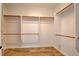 Walk-in closet with laminate floor features multiple hanging rods for storage at 2766 Mintlaw Ave, Henderson, NV 89044